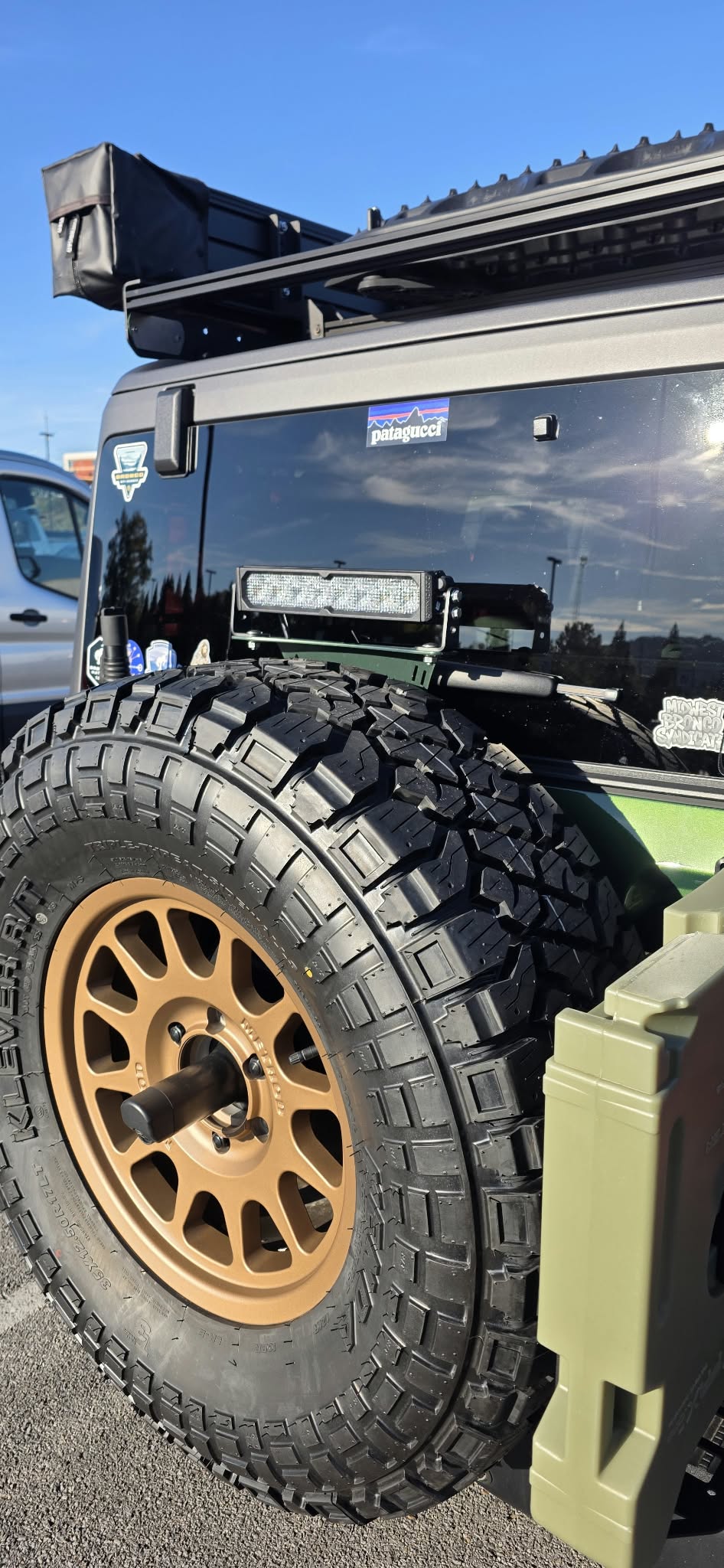 Diode Dynamics SS10 chase light mounted above the spare tire on a green Ford Bronco